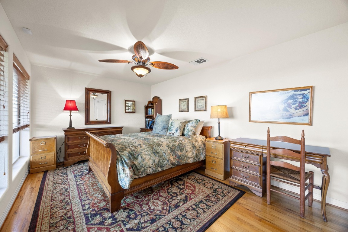 515 Coventry Road Spicewood, TX 78669 - Photo 30 of 36 a bed room with furniture and a chandelier