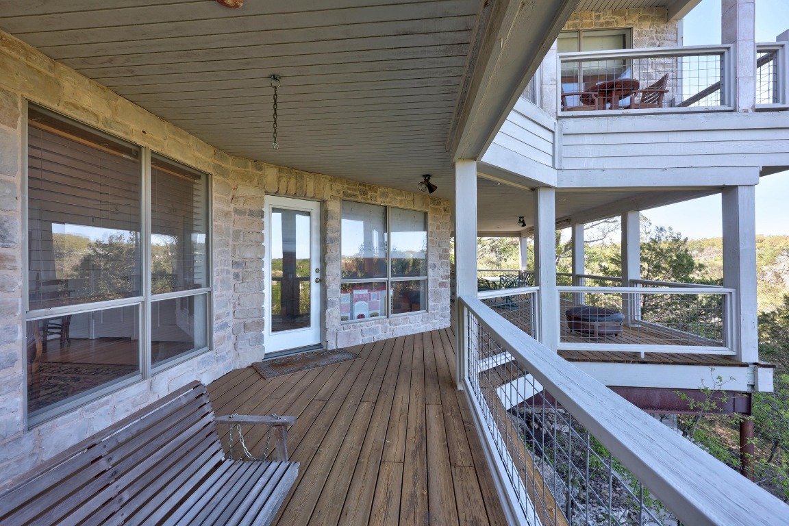 515 Coventry Road Spicewood, TX 78669 - Photo 31 of 36 a view of a balcony with wooden floor and outdoor space