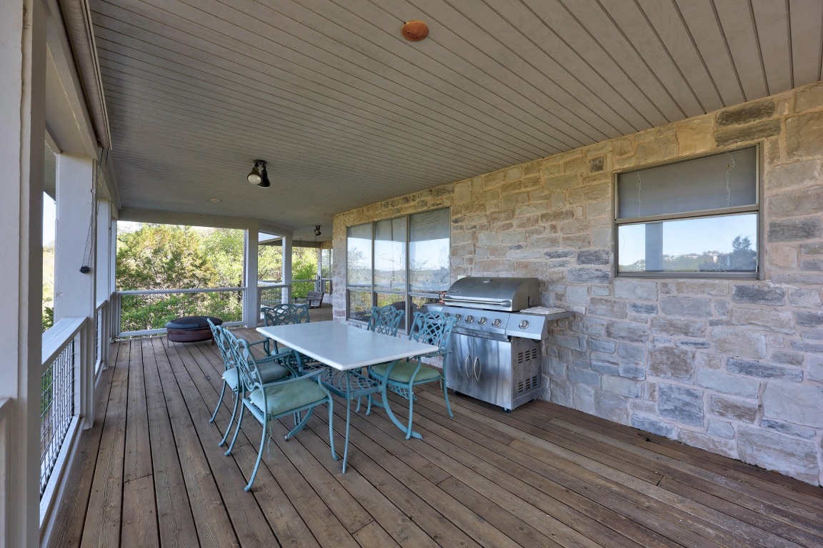 515 Coventry Road Spicewood, TX 78669 - Photo 32 of 36 a dining room with a wooden table and chairs