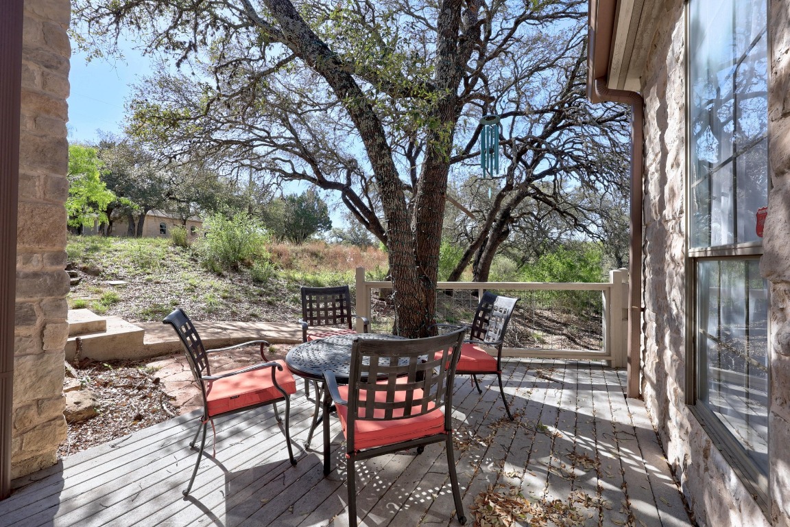 515 Coventry Road Spicewood, TX 78669 - Photo 8 of 36 a view of a chairs and table in backyard