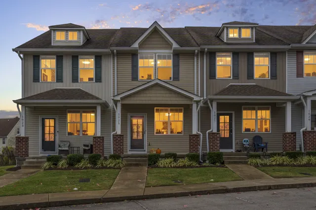 a front view of a residential apartment building with a yard