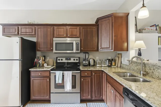 a kitchen with a sink stove and refrigerator