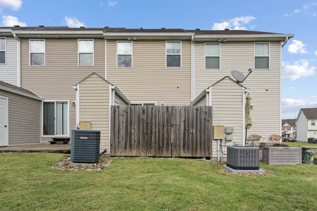 a view of a house with a yard and sitting area