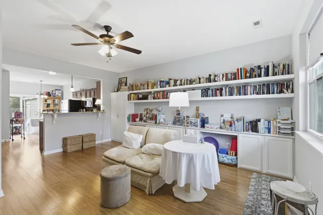 a living room with furniture and a kitchen view