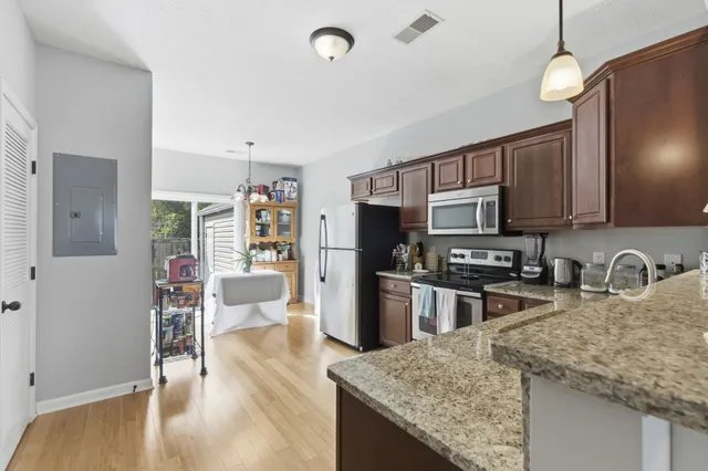 a kitchen with stainless steel appliances granite countertop a sink refrigerator and microwave