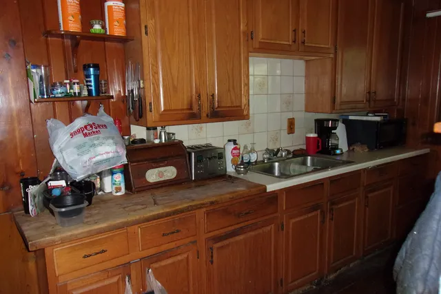 a kitchen with stainless steel appliances granite countertop a sink dishwasher stove and cabinets