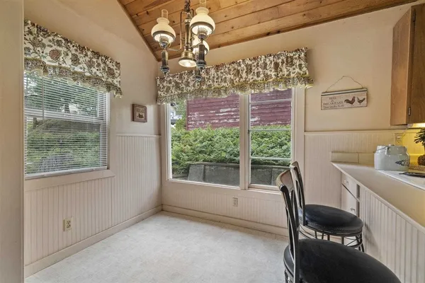 a view of a hallway with furniture and front door