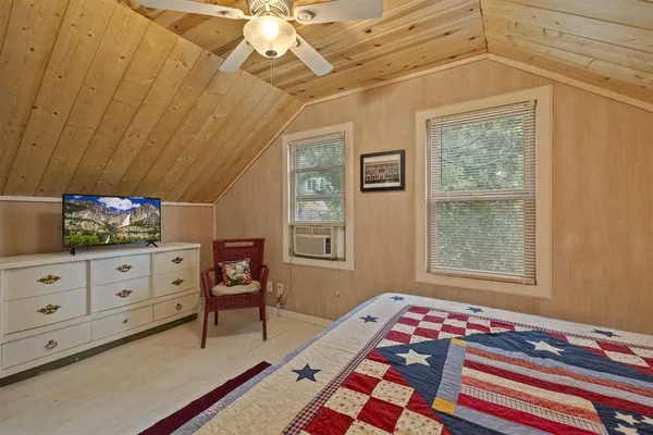a bedroom with furniture and a window