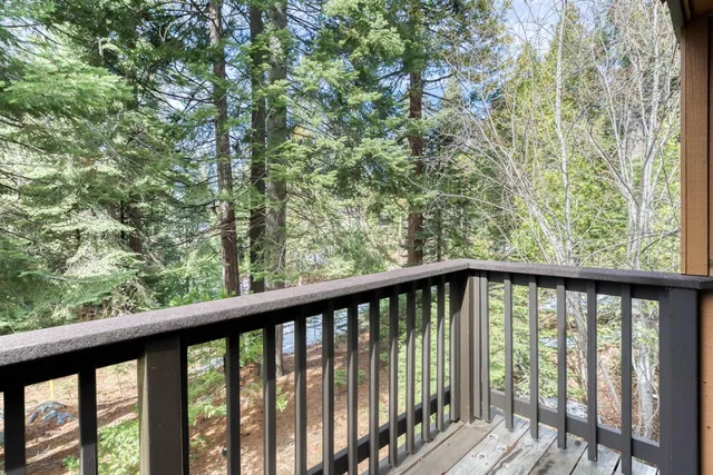 a view of a balcony with wooden floor and fence