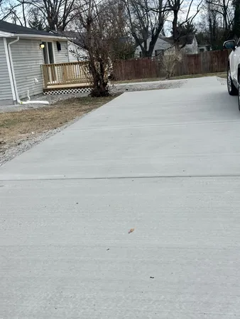 a view of garage with a car parked in front of it