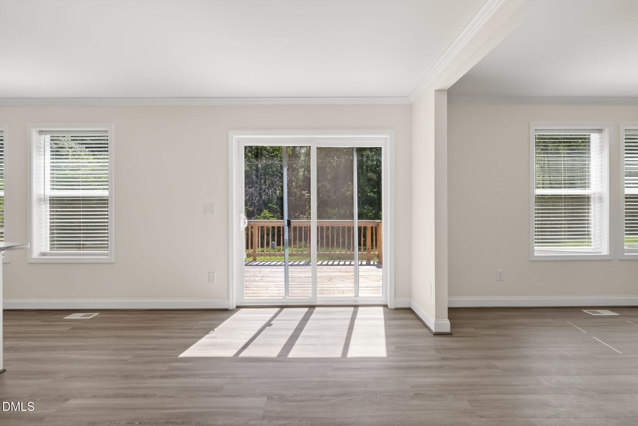 7122 Guess Road Hillsborough, NC 27278 - Photo 12 of 48 a view of an empty room with wooden floor and windows