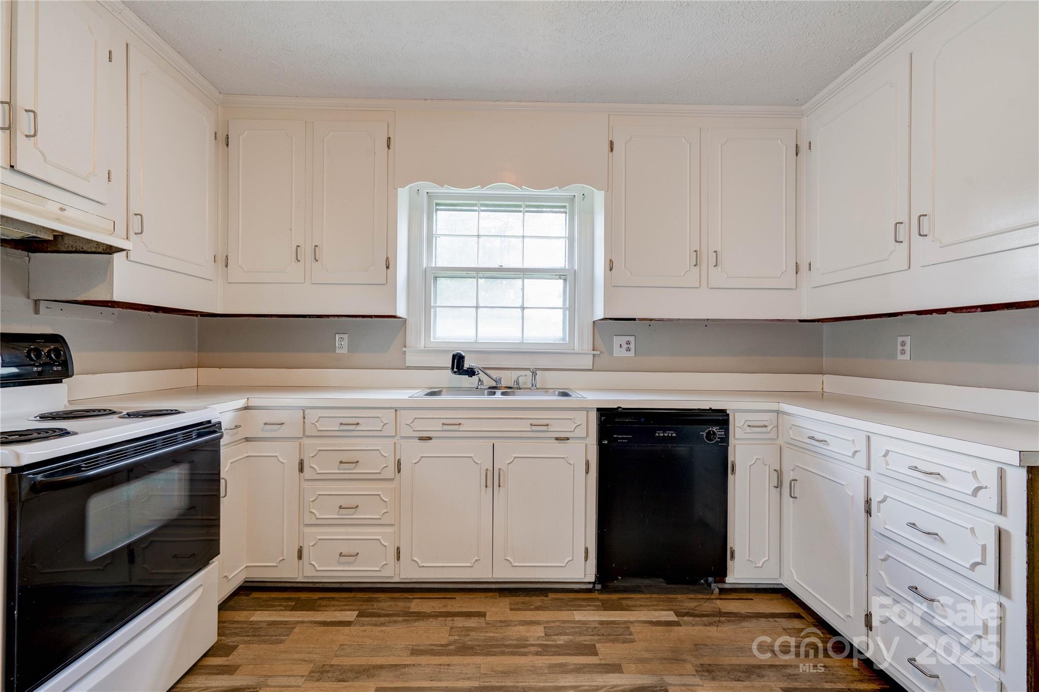 1414 South Post Road Shelby, NC 28152 - Photo 12 of 24 a kitchen with white cabinets appliances a sink and a window