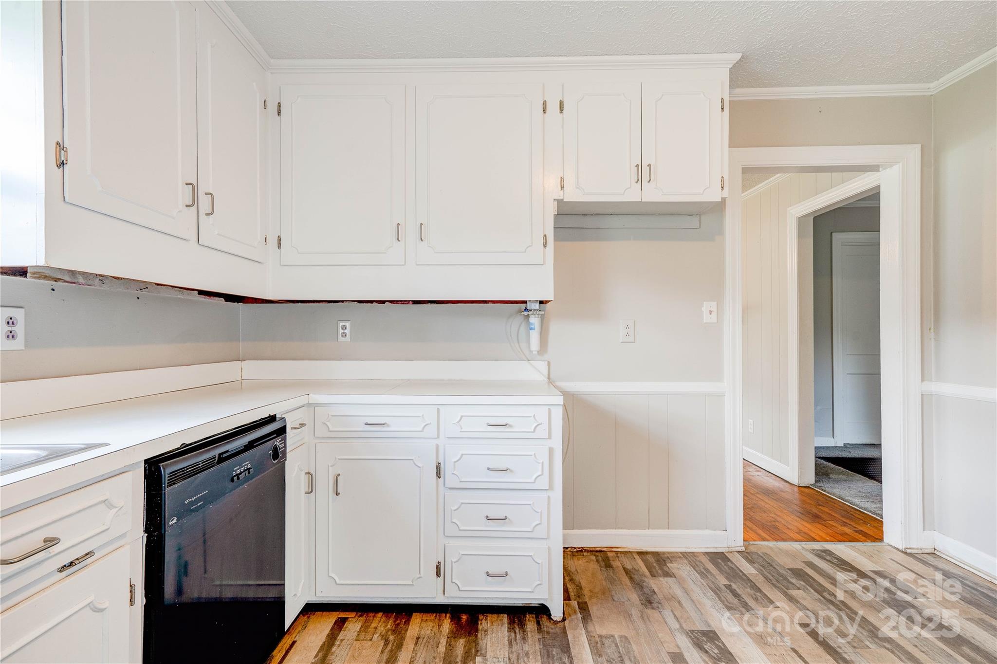 1414 South Post Road Shelby, NC 28152 - Photo 15 of 24 a kitchen with white cabinets and a stove with wooden floor