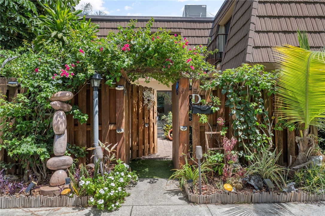 a couple of flower plants in front of a building