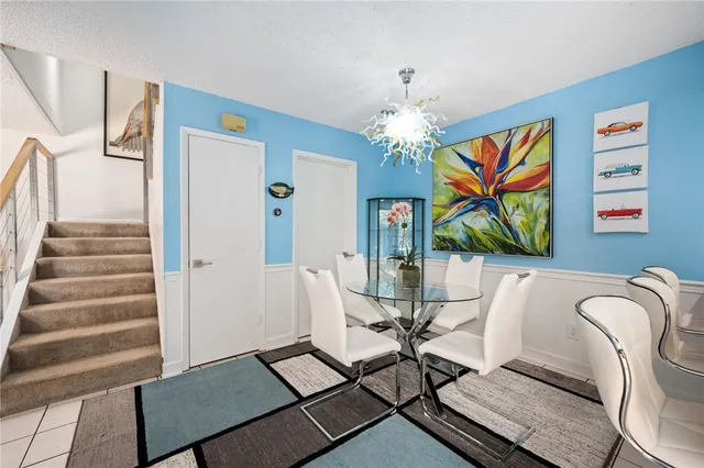 a view of a dining room with furniture wooden floor and a chandelier