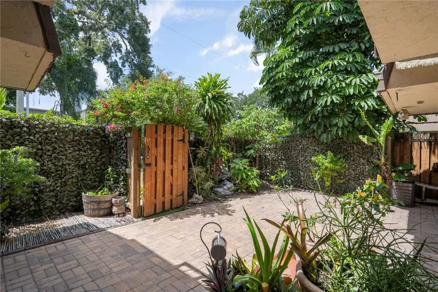 a view of a house with potted plants
