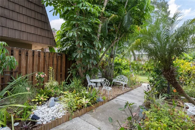 a front view of a house with a garden and plants