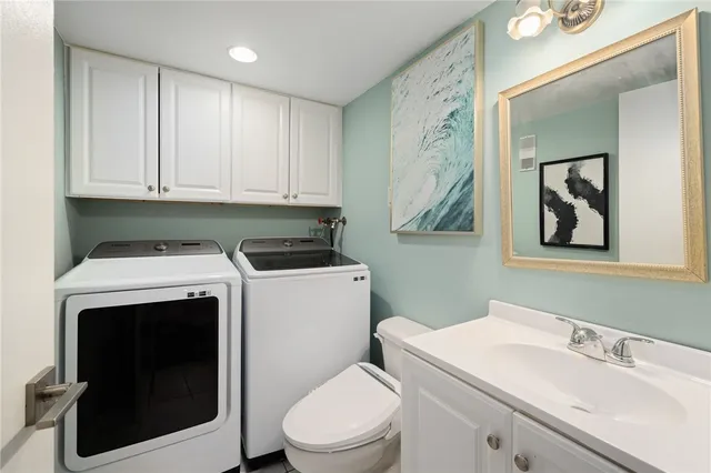 a bathroom with a sink a toilet and mirror