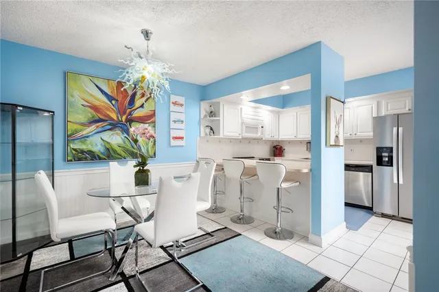 a living room with kitchen island furniture and a chandelier