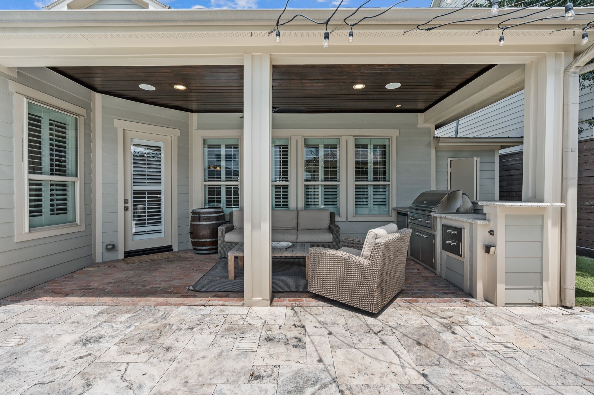 1217 Chippendale Road Houston, TX 77018 - Photo 33 of 42 Another view of the covered patio. A fully equipped summer kitchen makes outdoor entertaining effortless, featuring a stainless steel grill, stainless steel beverage refrigerator, granite countertops, & built-in storage. Conveniently positioned beneath the covered patio w/ direct views of the pool & backyard.