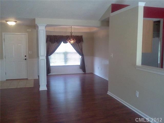 122 Elrosa Road Mooresville, NC 28115 - Photo 9 of 16 an empty room with wooden floor chandelier and entryway