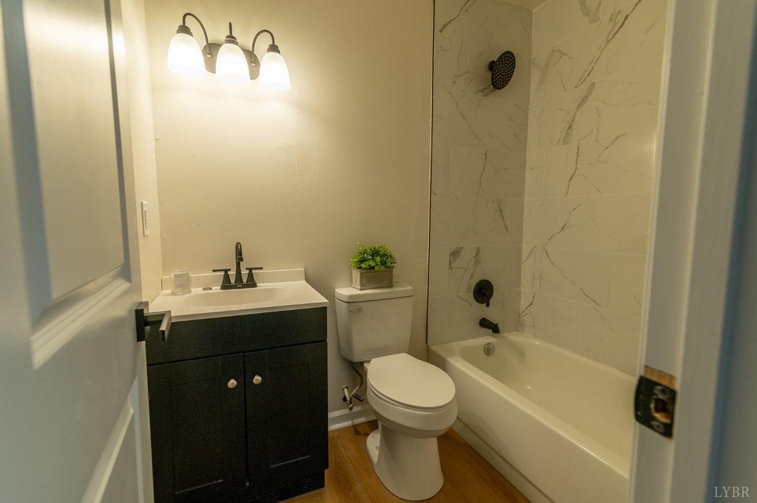 419 Robinson Road Appomattox, VA 24522 - Photo 11 of 19 a bathroom with a sink a toilet and shower