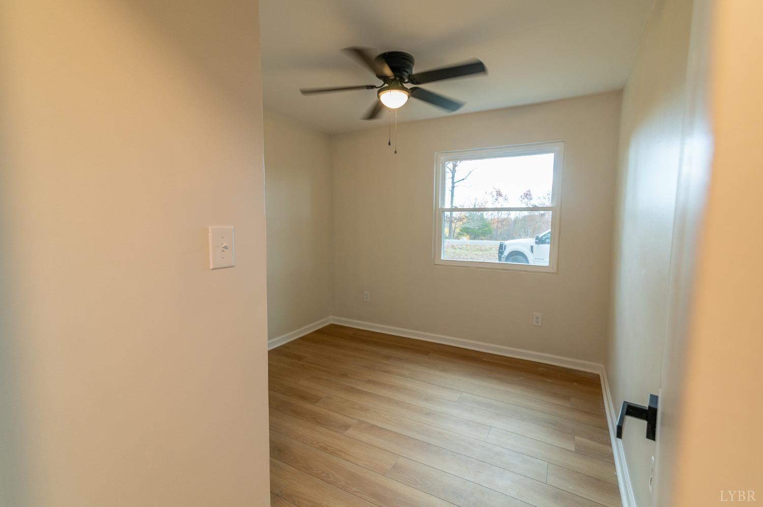 419 Robinson Road Appomattox, VA 24522 - Photo 12 of 19 an empty room with a window and a fan