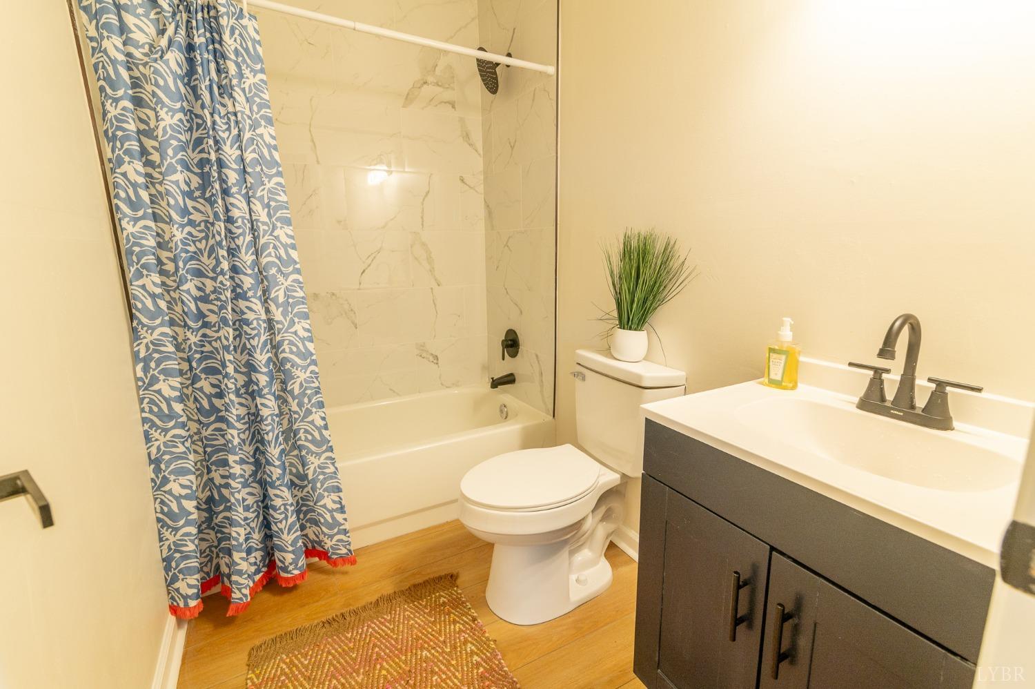419 Robinson Road Appomattox, VA 24522 - Photo 14 of 19 a bathroom with a sink toilet and shower