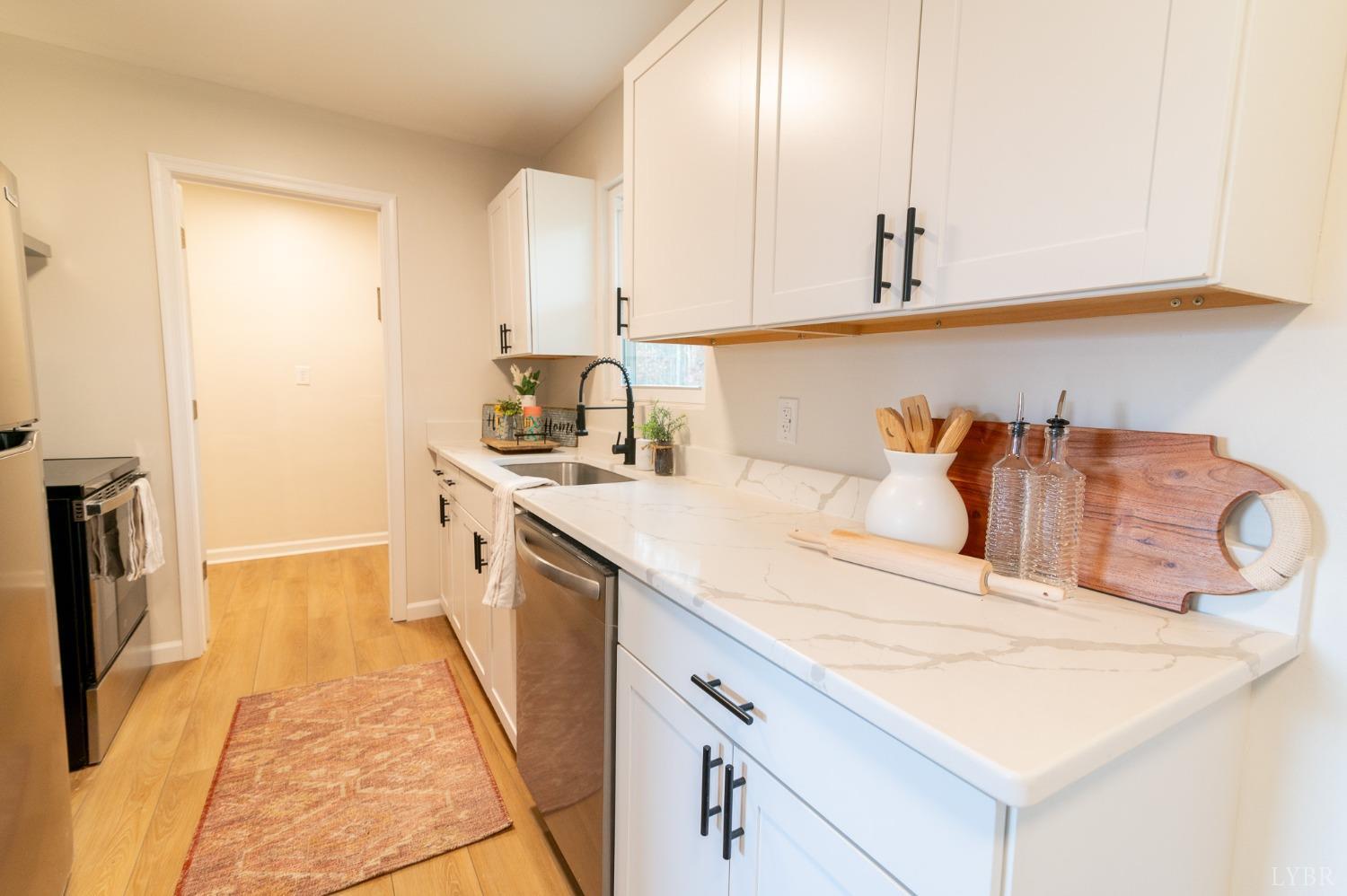 419 Robinson Road Appomattox, VA 24522 - Photo 6 of 19 a kitchen with stainless steel appliances granite countertop a sink and dishwasher a oven with white cabinets