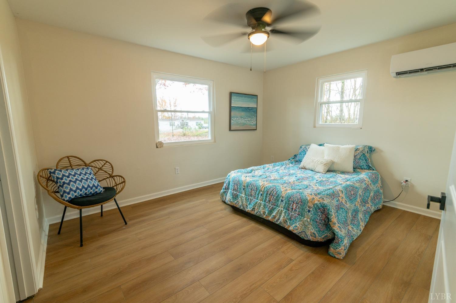 419 Robinson Road Appomattox, VA 24522 - Photo 8 of 19 a bedroom with a bed and a chair