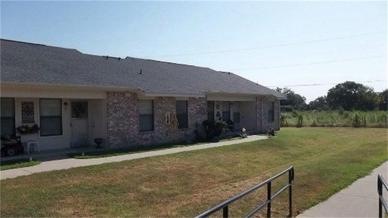 401 Bicentennial Street Bonham, TX 75418 - Photo 5 of 6 a view of a house with backyard and garden
