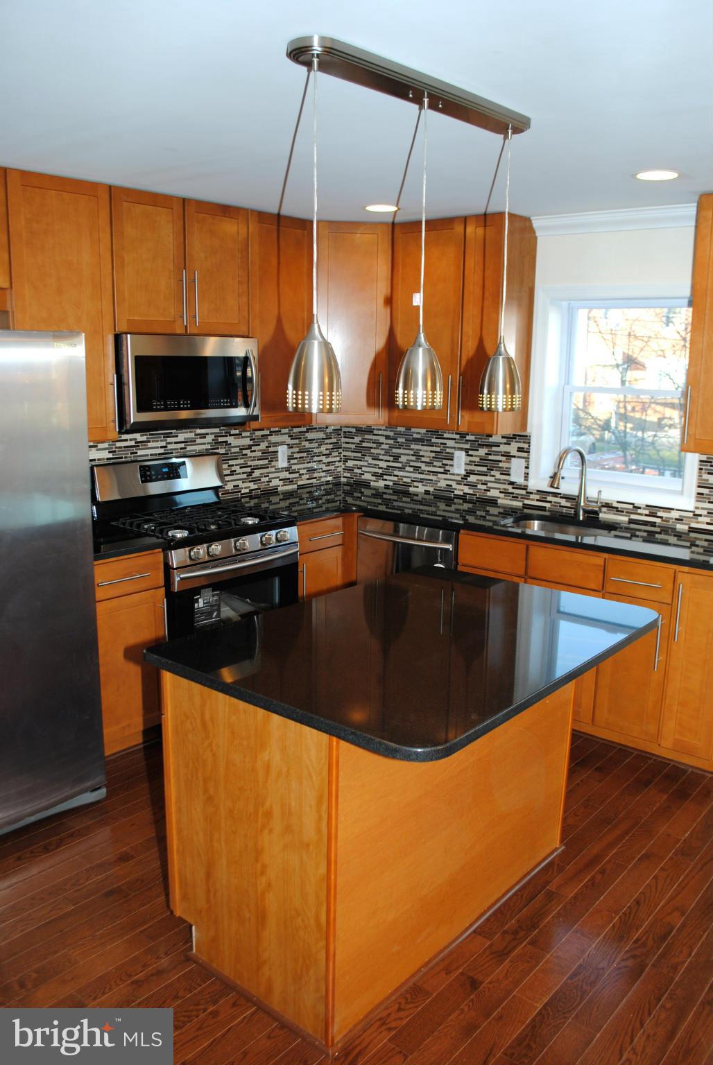 1730 Ingram Road Baltimore, MD 21239 - Photo 14 of 30 a kitchen with stainless steel appliances granite countertop a stove a sink and a microwave