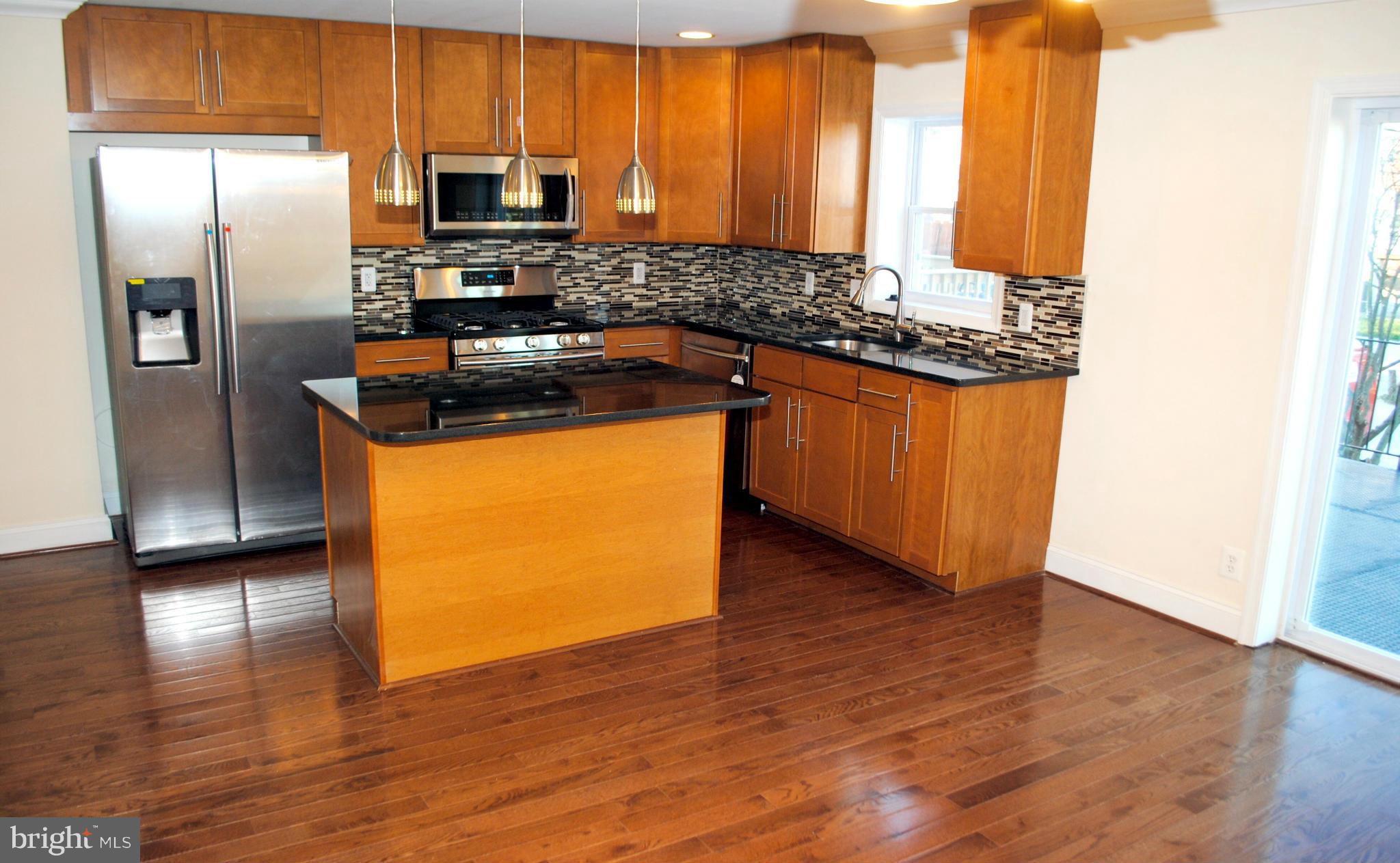 1730 Ingram Road Baltimore, MD 21239 - Photo 8 of 30 a kitchen with granite countertop a refrigerator and a sink