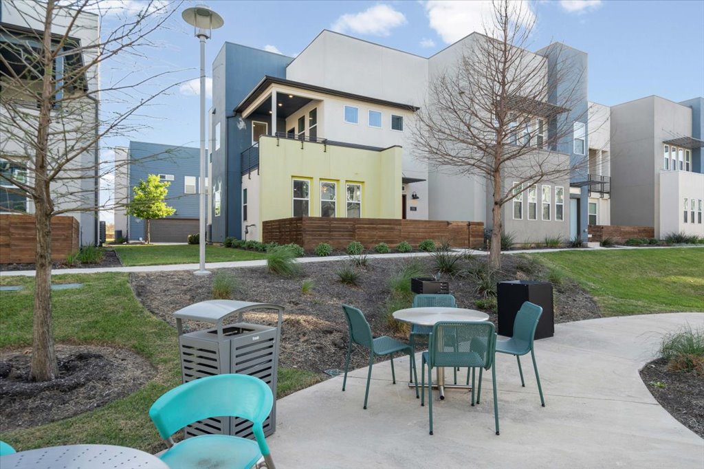 9015 Cattle Baron Path, Unit 705 Austin, TX 78747 - Photo 27 of 35 a view of a patio with a table and chairs