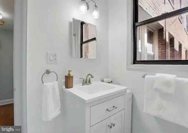 a bathroom with a sink and a window