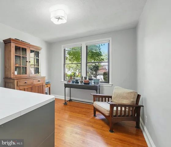 a view of a room with a window and wooden floor