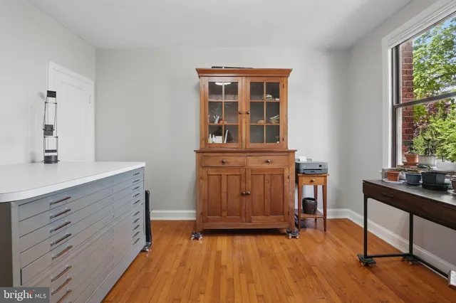 a living room with furniture and a flat screen tv with wooden floor