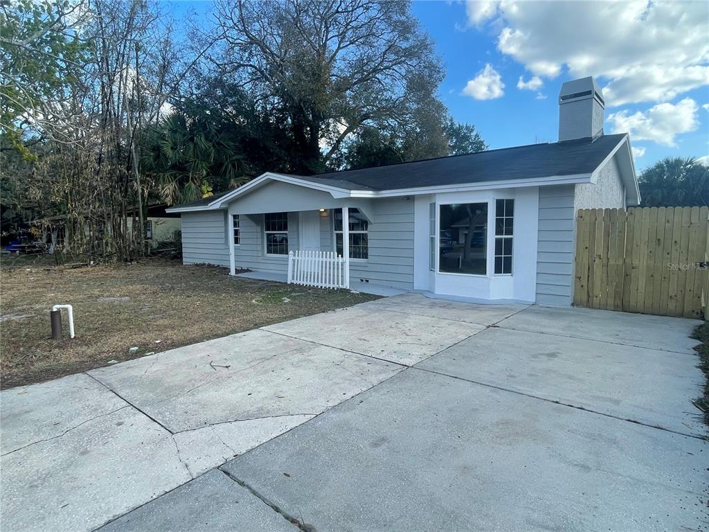 6746 Old Main Street New Port Richey, FL 34653 - Photo 1 of 39 a view of a house with a yard and large tree