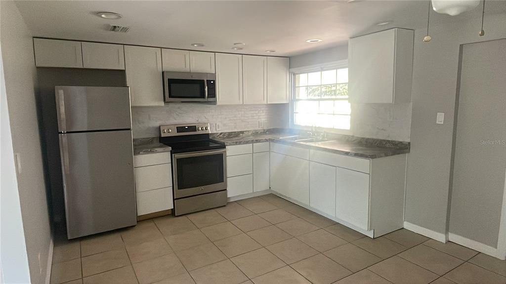 6746 Old Main Street New Port Richey, FL 34653 - Photo 11 of 39 a kitchen with a sink stove and refrigerator