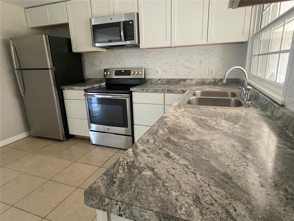 6746 Old Main Street New Port Richey, FL 34653 - Photo 16 of 39 a kitchen with a sink stove and refrigerator