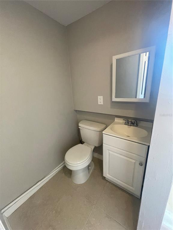 6746 Old Main Street New Port Richey, FL 34653 - Photo 19 of 39 a white toilet sitting next to a white sink and vanity