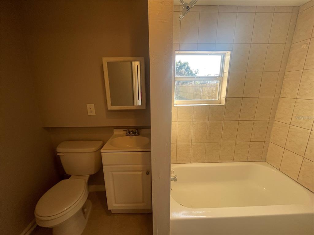 6746 Old Main Street New Port Richey, FL 34653 - Photo 20 of 39 a white toilet sitting next to a bathtub