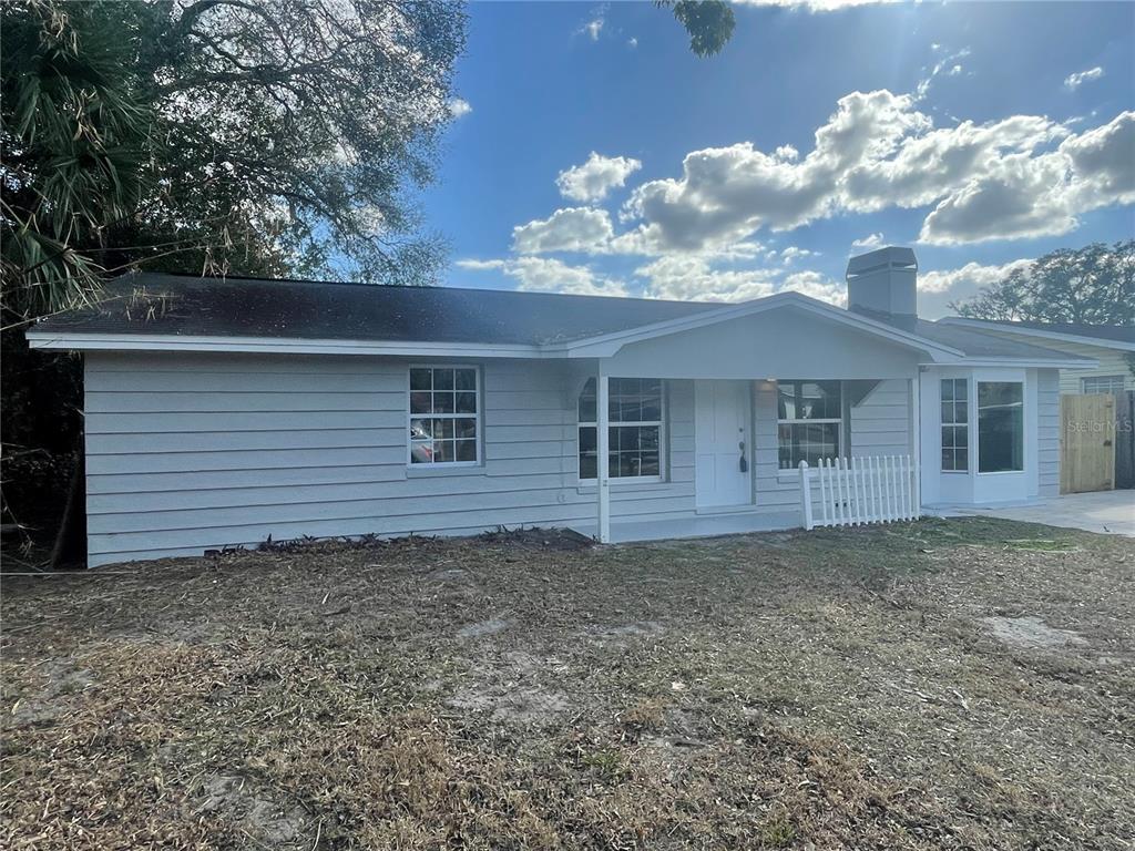 6746 Old Main Street New Port Richey, FL 34653 - Photo 2 of 39 a front view of a house with garden