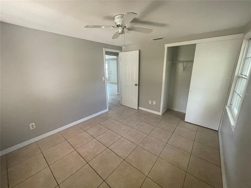6746 Old Main Street New Port Richey, FL 34653 - Photo 29 of 39 a view of an empty room and window chandelier fan