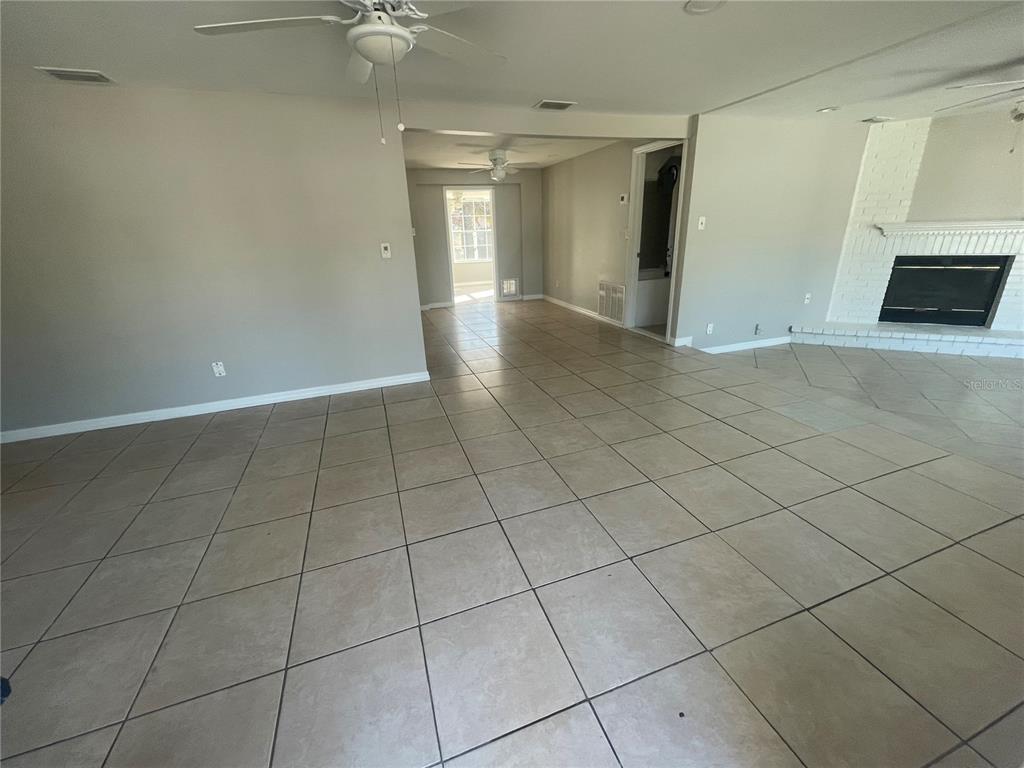 6746 Old Main Street New Port Richey, FL 34653 - Photo 4 of 39 an empty room with a fireplace and windows