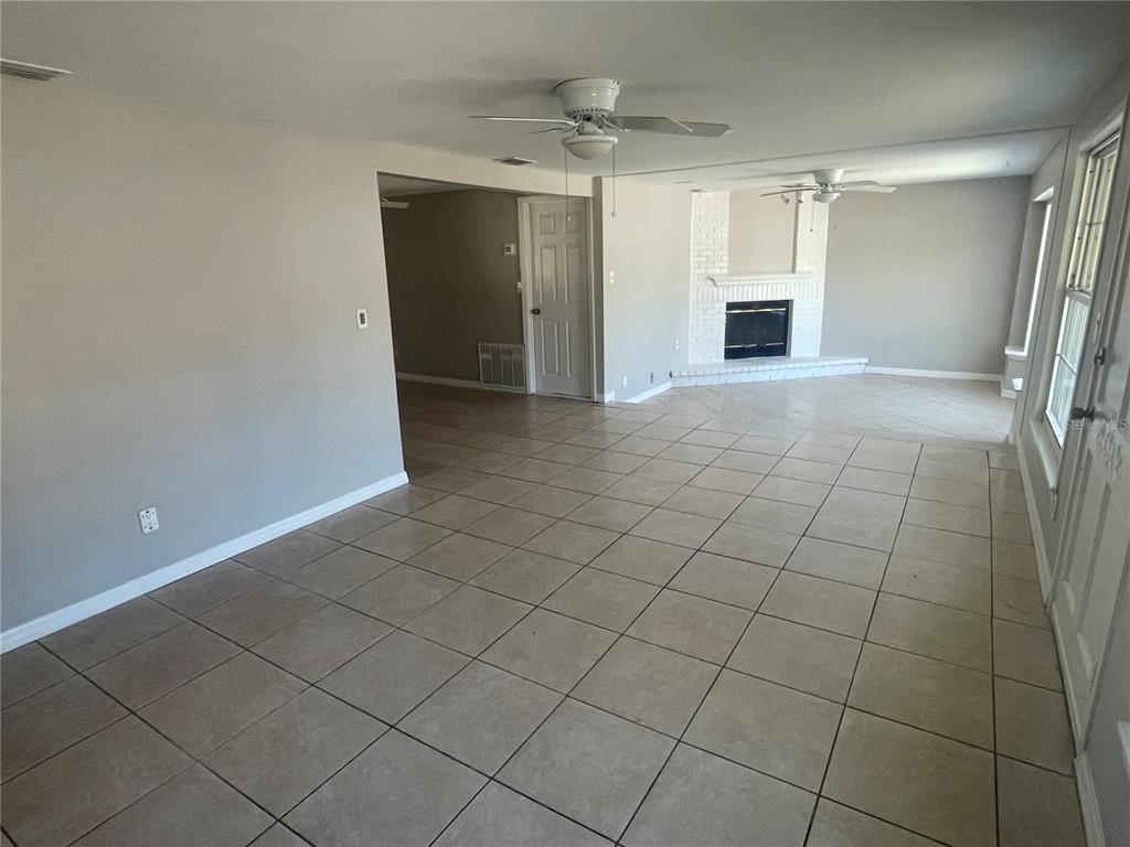 6746 Old Main Street New Port Richey, FL 34653 - Photo 6 of 39 a view of empty room with kitchen and window