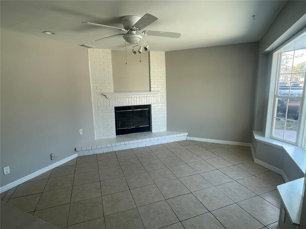 6746 Old Main Street New Port Richey, FL 34653 - Photo 8 of 39 an empty room with windows and fireplace