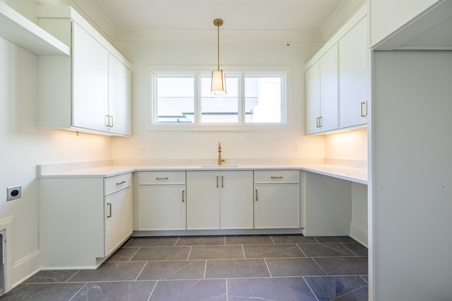 an empty room with a window and a ceiling fan
