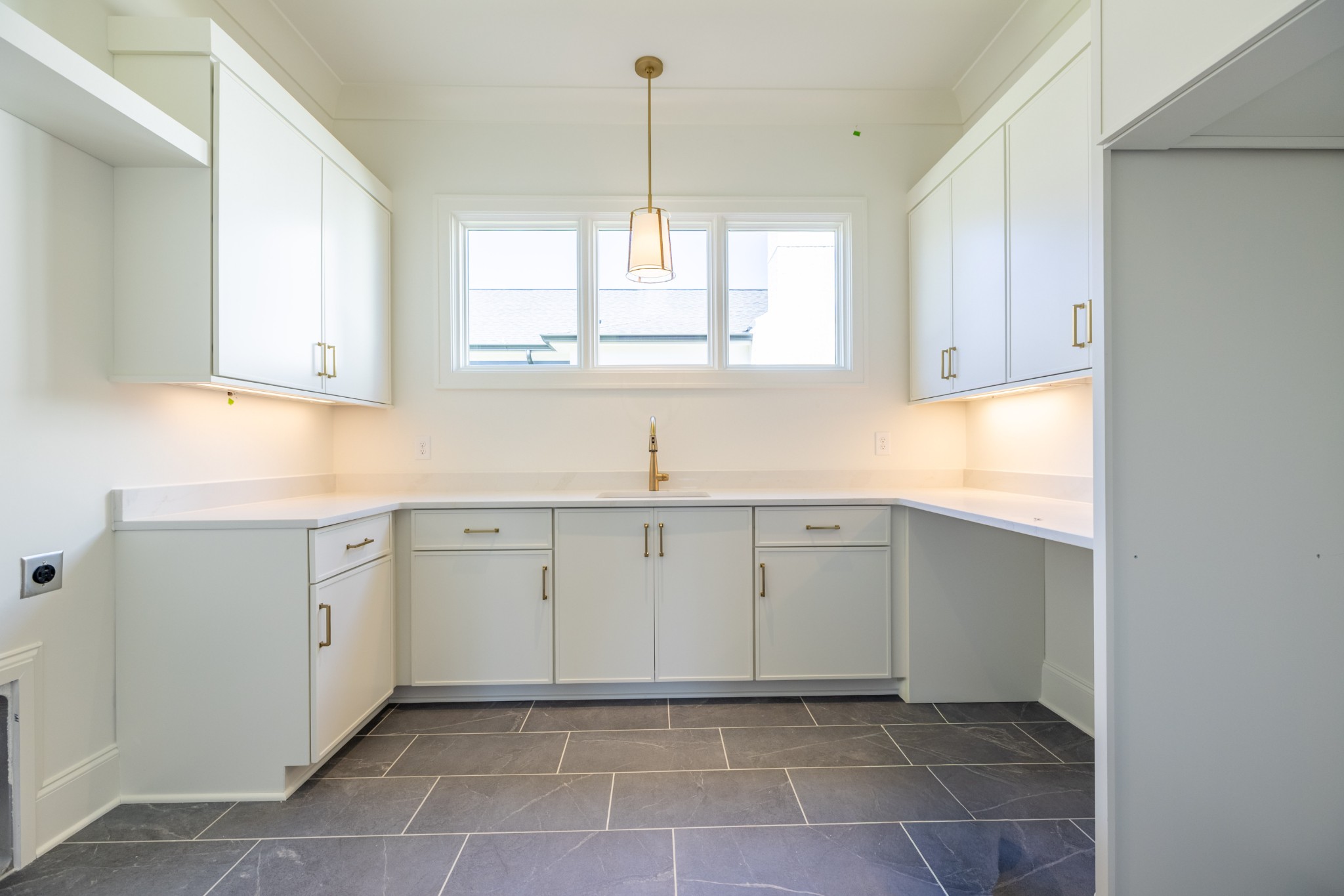 7017 Kinderhook Road Nashville, TN 37221 - Photo 15 of 43 a kitchen with a sink window and cabinets