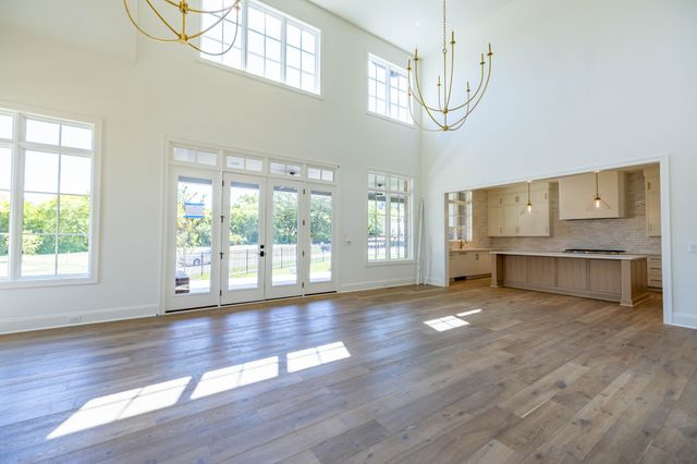 a kitchen with a sink window and cabinets